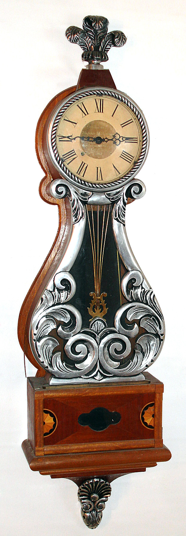 Modern lyre presentation wall clock in impressive full size case. Clock has silvery cast metal front, bezel, bottom, and finial, dial inscription "Virginia P. Timmans, Southwestern Chapter 15, NAWCC 1968", c1968 — Antique Clocks Price Guide