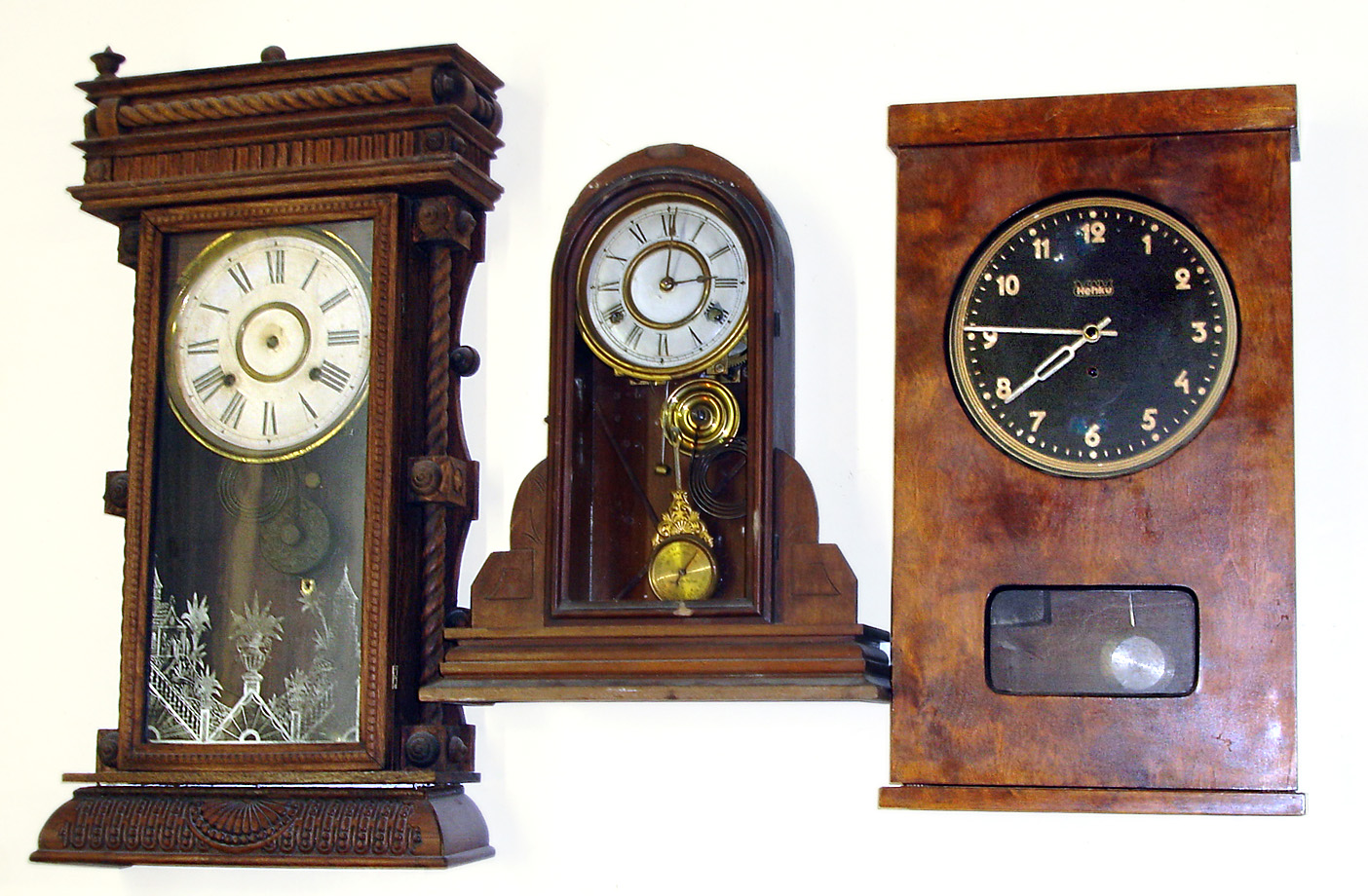 Three 8 day wood shelf clocks. Smallest is New Haven with indicator pendulum (no tablet). Middle is Henku time only weight driven. Best and largest is Gilbert "Long Branch", 28" tall. — Antique Clocks Price Guide