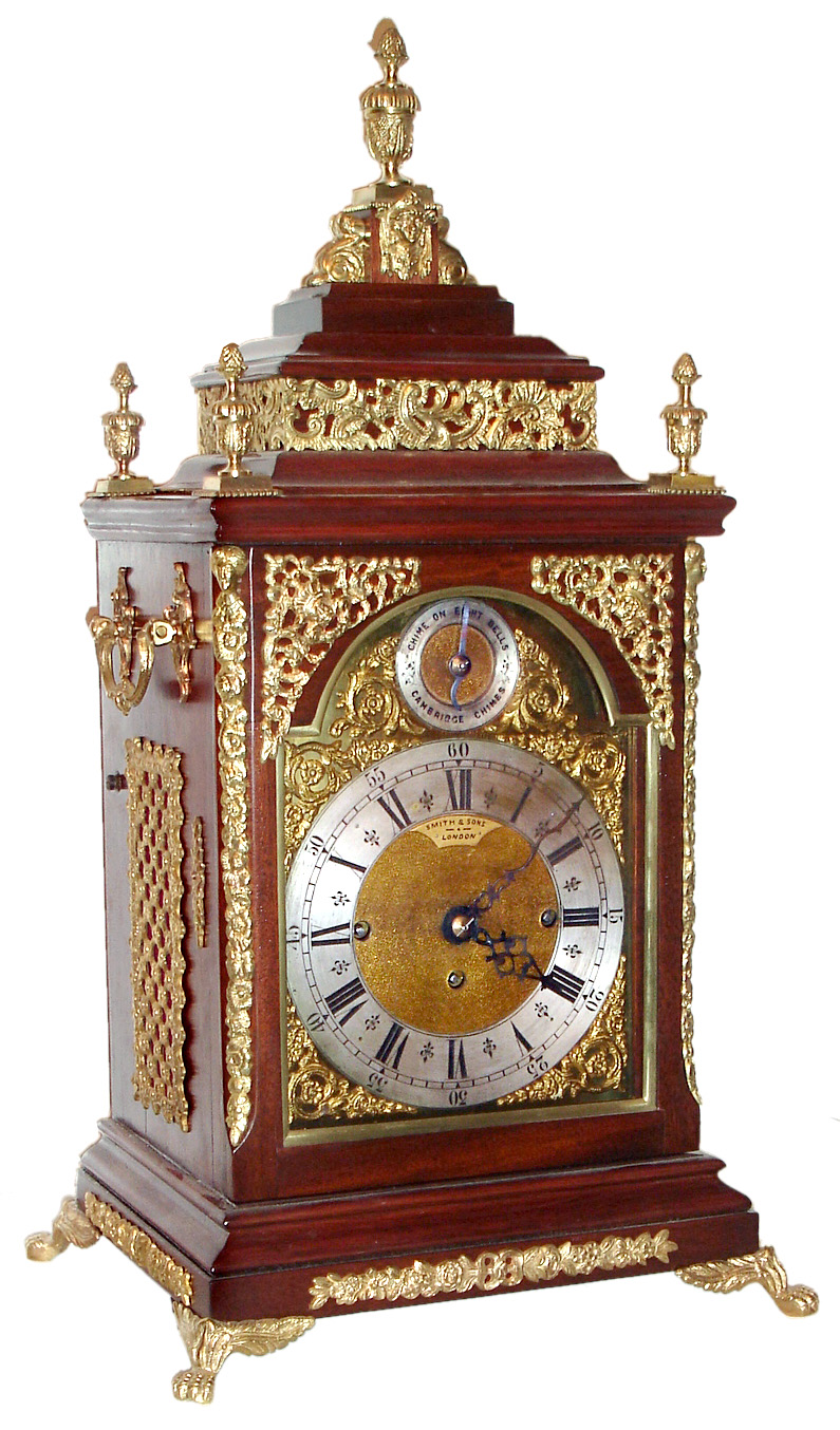 English, Smith and Sons, London, 3-fusee, quarter chiming bracket clock, mahogany case with arched dial, cast spandrels and applied silvered chapter ring. Chimes the quarters on a nest of 8 bells (choice of tune), and strikes the hour on a large cathedral gong, c.1900 — Antique Clocks Price Guide