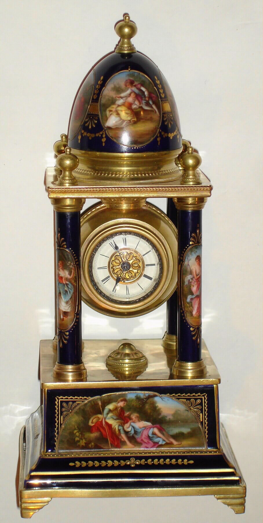 Austrian, unsigned Royal Vienna case, blue cobalt, in the Empire style with 4 columns, the base and top dome with finely detailed cameos showing amorous/pastoral scenes, all brightly trimmed in gold, and with an 8 day cylinder platform movement suspended from the top (wound from the rear), c1870 — Antique Clocks Price Guide