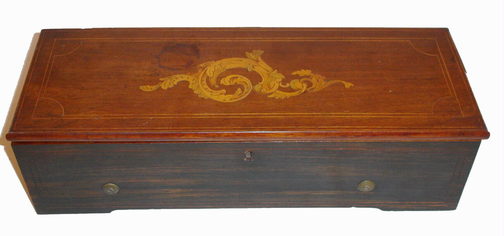 Swiss, Geneva, Nicole Freres, 6-Tune music box, separate key wound from left side, in a box with rosewood graining to front and sides and with a mahogany veneered lid with shell inlay. C.1855 — Antique Clocks Price Guide