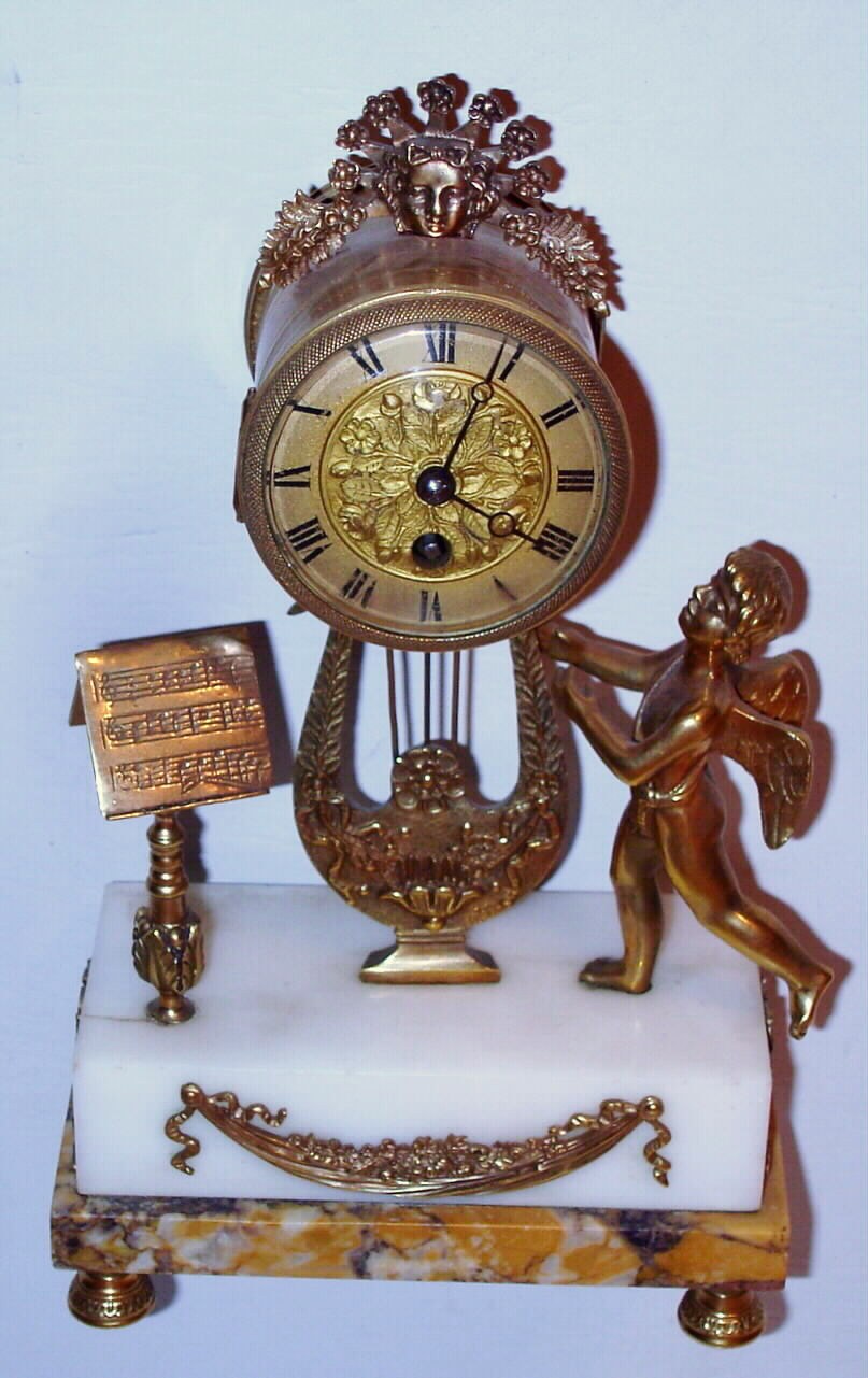 French, 8 day, platform movement small marble and gilt figural table or desk clock. c. 1900 — Antique Clocks Price Guide