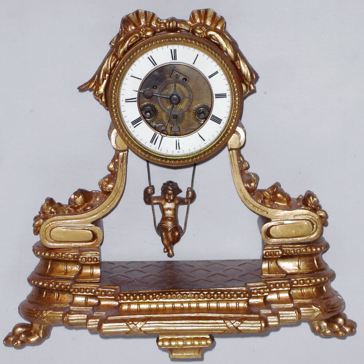 French cast metal mantel clock with swinging cupid for pendulum and 8 day time and strike spring driven movement, c1890 — Antique Clocks Price Guide