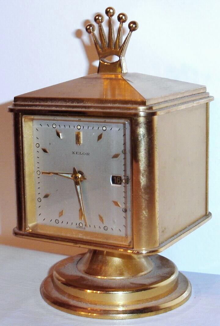 Angelus Watch Co., Switzerland desk clock and barometer with 15J stem wind stem set Angelus signed nickel movement in polished brass case with silvered metal dials and date window, c1950 — Antique Clocks Price Guide