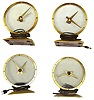 Four Golden Hour electric mystery clocks. All complete with undamaged glass and red plastic bottom covers.