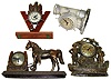 Four electric cast metal figural clocks. Includes United Pirates, "Howard" V and eagle, Admiral lighthouse lamp, and Sessions horse and lucky horseshoe. Tallest is 13" high.