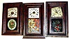 Three ogee 30 hour weight driven shelf clocks- an Ansonia Brass and Copper with colorful later painted glass of autumn foliage, a Seth Thomas with early oval floral glass and an E. and A. Ingraham (Waterbury movement) with later but well done floral tablet. Tallest, with extra bottom molding, is 27" high