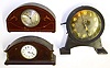 Three quality European desk clocks. Two are nice inlaid solid wood cases and balance wheel 8 day time only movements; one Swiss, one English with walking lion trademark and Henry Birks and Sons enamel dial. Third is British novelty with barbell pendulum, visible escapement and interior weight lifted by side lever, 10.5" high.