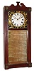 Attributed to Abiel Chandler, Concord, NH "Mirror Clock" 8 day time and rat-trap strike two weight driven movement in mahogany case with four pressed brass corner rosettes and reverse painted dial surround and painted metal dial, c1830