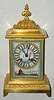 French, a desk clock with 3 porcelain panels (one with dial), bearing marine / sail boat themes, and with a bell strike movement bearing the Japy Freres logo and with pendulum regulation through the dial above 12, c1890