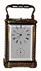 French, Brass Cased Carriage clock for the Asian market, center seconds, the case decorated with silvered brass filigree on the base, quarter columns and top, and with center seconds. The rear plate has markings for Alarum (sic) wind and Alarum set, plus cuneiform markings, perhaps from Tokyo or S'pore. In any case this is a rear plate rack and snail model that has been widely reproduced in China, and it is likely they used one of this model to copy, c1900