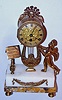 French, 8 day, platform movement small marble and gilt figural table or desk clock. c. 1900