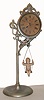 Ansonia Clock Co., "Jumper No. 1", 30 hour bobbing doll novelty timepiece. Movement supported by a single pole, nickel plated stand, the pin pallet movement runs by the action of the ceramic doll bobbing up and down. Doll is a replacement. c.1894