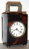 French, 8 day miniature carriage timepiece in a tortoise shell case with London 1912 hallmarked sterling silver handle, feet, latch and bezel, c1900