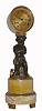 French, Canchy, a Paris, a bronze and marble mantel clock, slender in nature, with a finely finished seated cherub, a tambourine at his feet and arms folded, surmounted by a fluted brass canister containing a well made bell strike movement with 60-pin escape wheel and silk thread suspension. C.1825.
