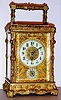 French carriage clock time and half hour strike on gong with alarm and platform lever escapement in embossed Rococo case with pierced gilt mask decorated with lions around Arabic numeral enamel chapter ring, c1900