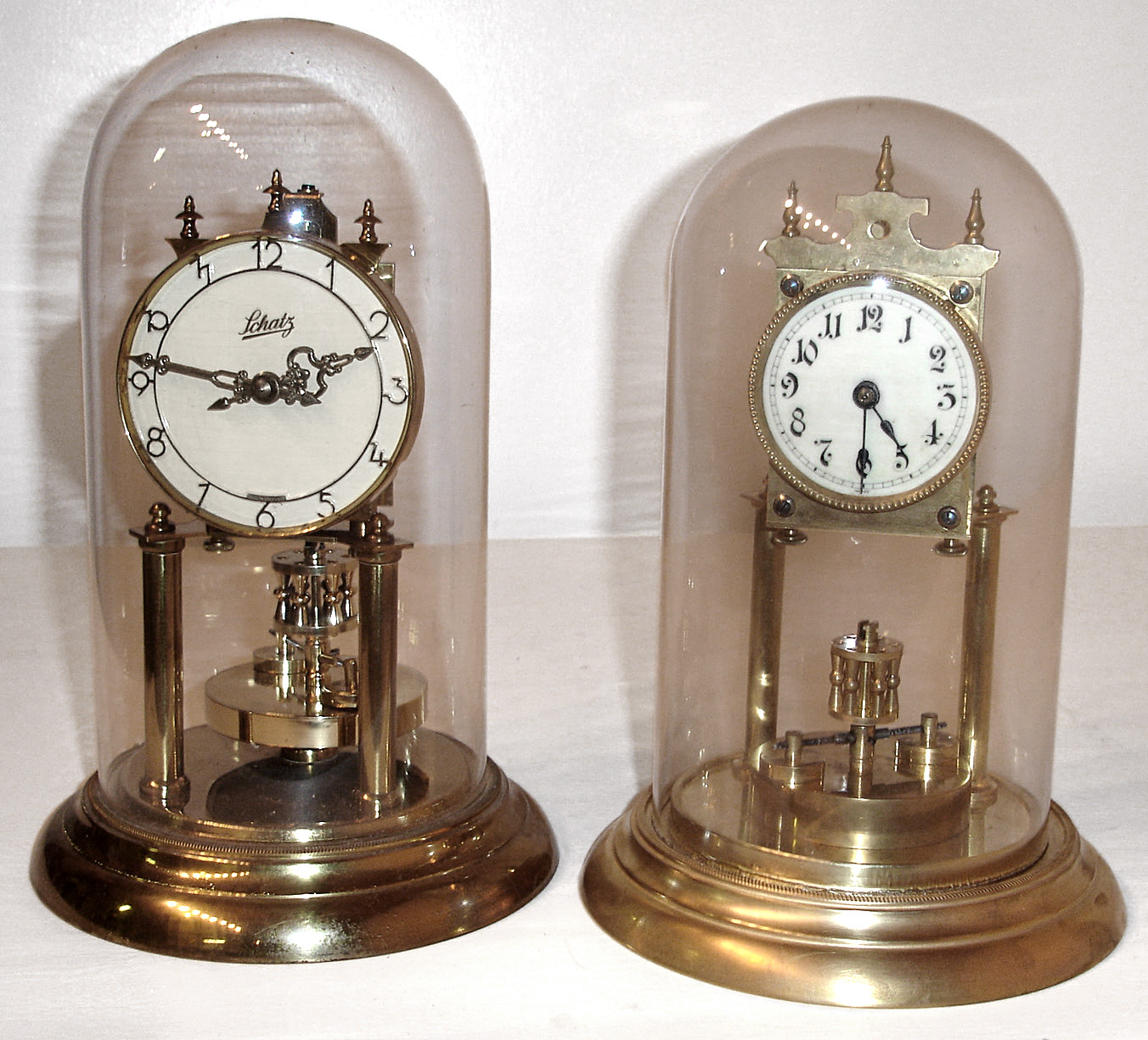 Clocks- 2 (Two) German 400 day disk pendulum brass clocks with glass domes, 20th century — Antique Clocks Price Guide