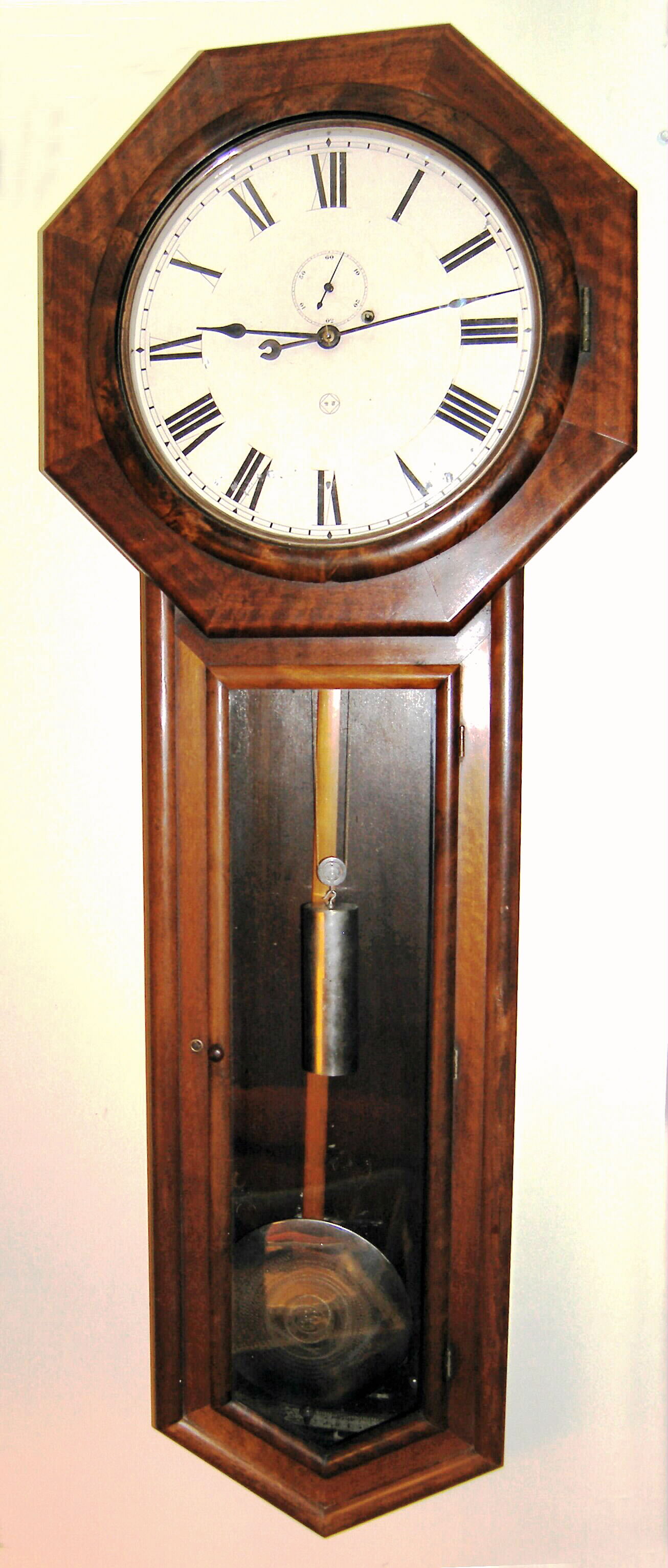 Seth Thomas Clock Co., Thomaston, Conn., "REGULATOR No. 18" walnut cased long drop octagon, weight driven, meter pendulum and with large nickel plated bob with damascene pattern, plus matching weight and pulley, c1883. — Antique Clocks Price Guide