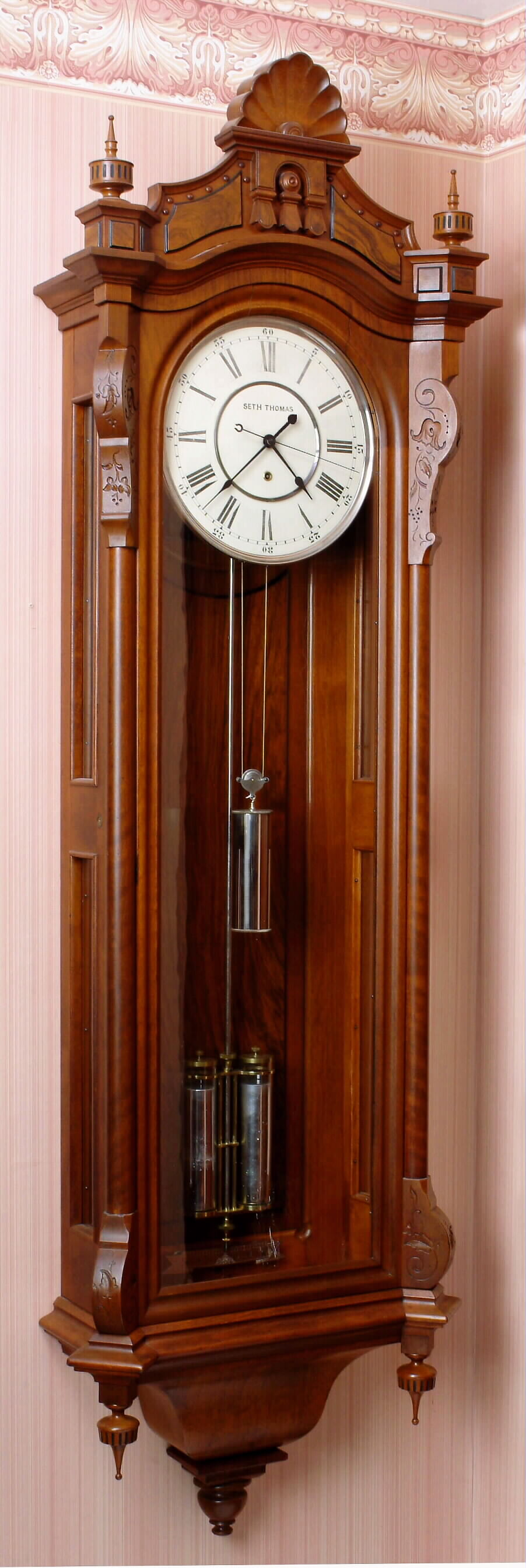 Seth Thomas Clock Co., Thomaston, Conn., "REGULATOR No. 19", in walnut with burled appliques, wall regulator with 2- jar compensating pendulum, weight driven and with center seconds hand, c1885 — Antique Clocks Price Guide
