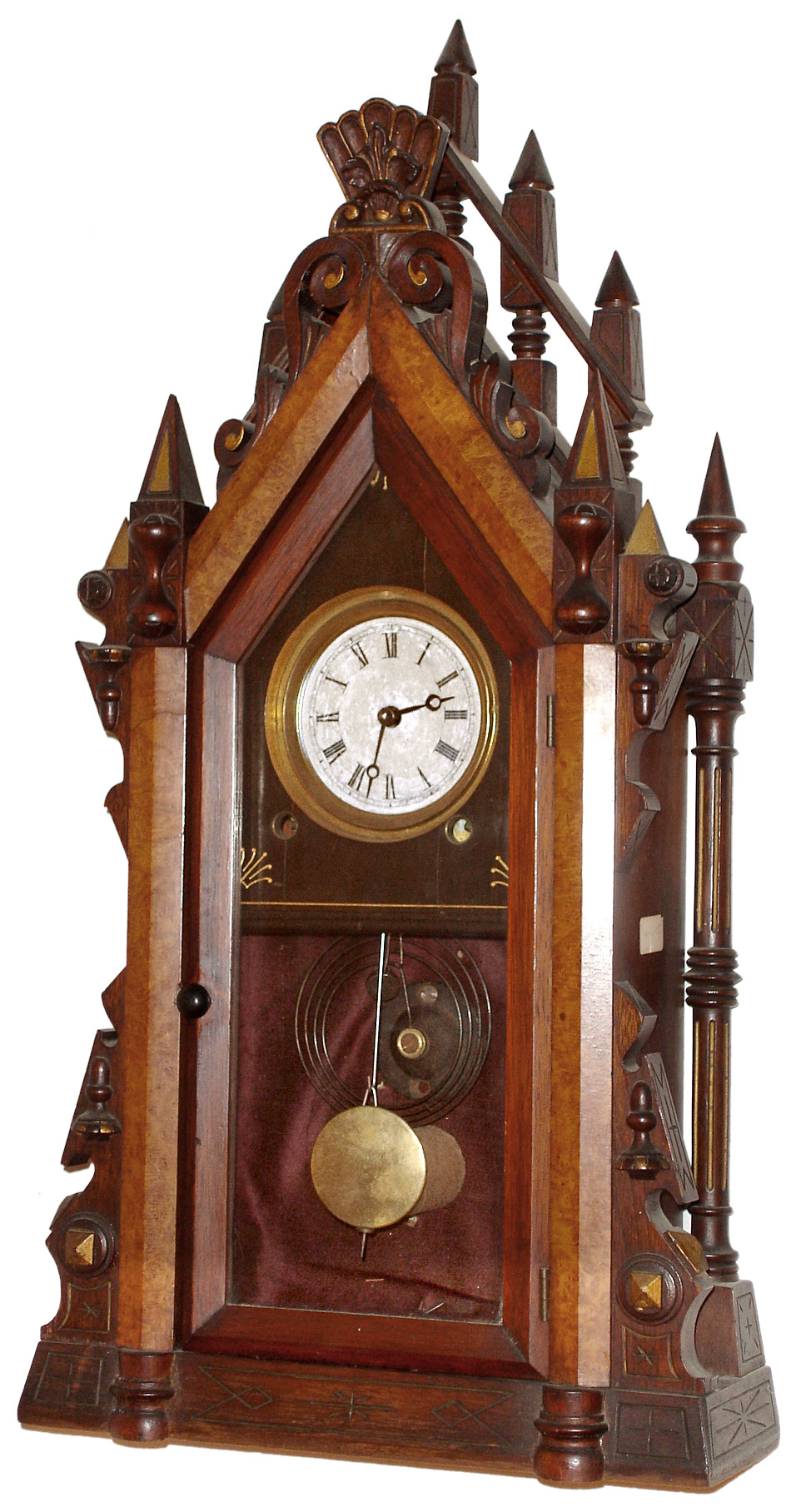 Unknown, 8 day time and strike steeple clock variant. We have never seen this model before. It could have been made by an individual craftsman as it is fitted with a Terry and Andrews movement that dates from an earlier period. It does not appear to be a factory made clock as the backboard is made from walnut which is a wood not normally used for that purpose. If it was a manufactured piece, a movement closer to the age of the case and fancy pendulum would have been chosen, c1880 — Antique Clocks Price Guide