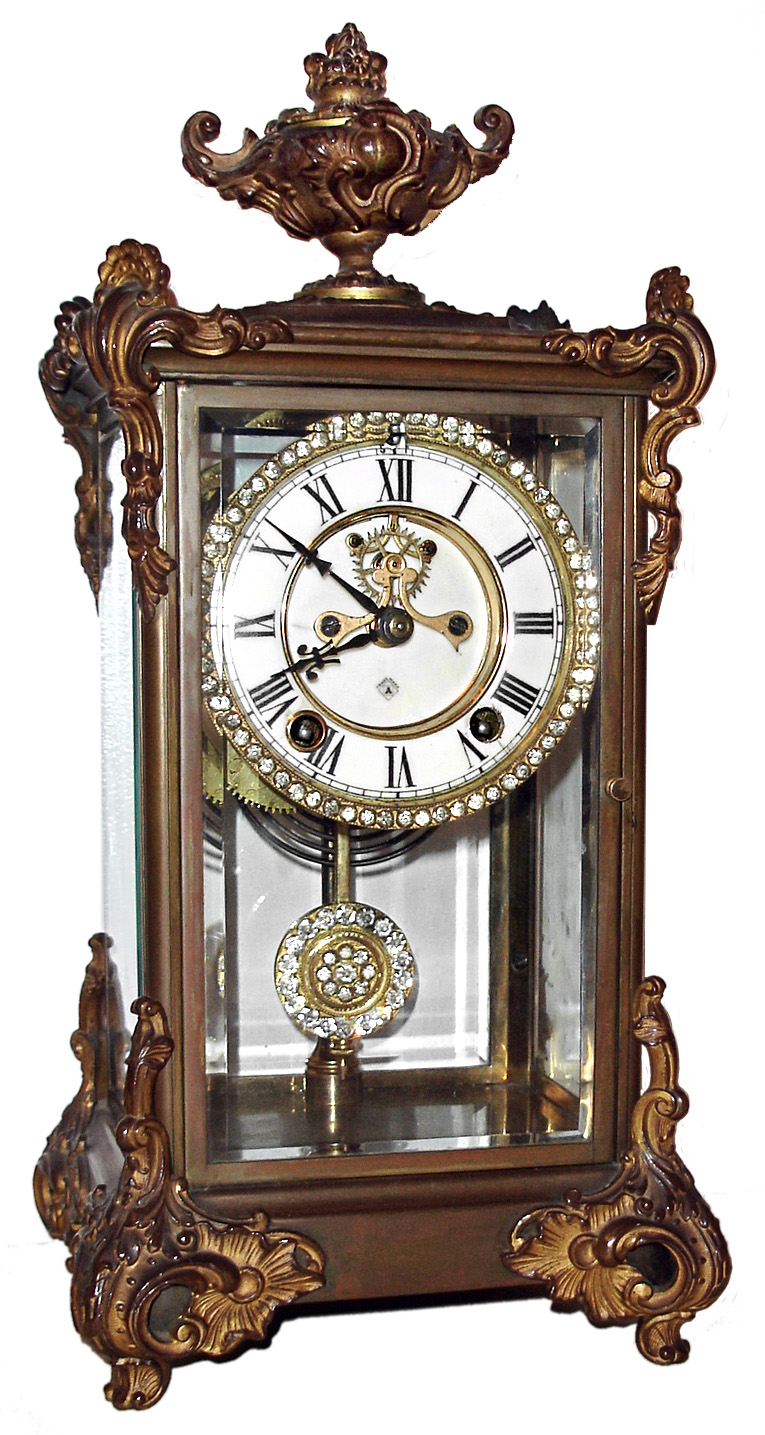 Ansonia Clock Co., New York, "Marquis" crystal regulator, 8 day, time and strike, spring driven movement with open escapement in brass case with rhinestone highlights on dial and pendulum, c1905 — Antique Clocks Price Guide