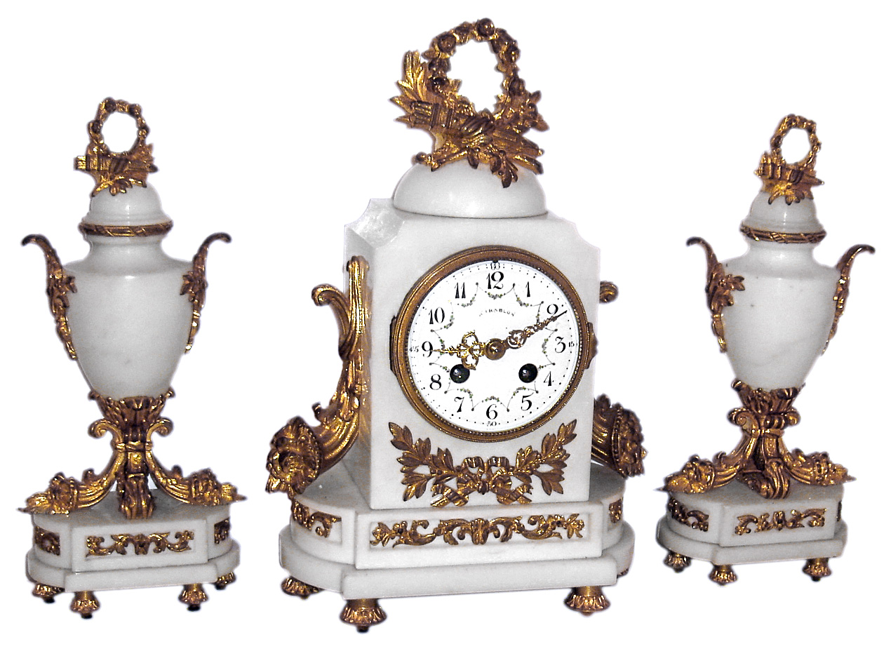 French for Mirablon, three piece garniture mantel clock, 8 day, time and bell strike, spring driven movement in a white marble case with ormolu trim, flanking cornucopia decorations and matching side pieces. The multicolor white enamel dial is signed with retailers name, c1890 — Antique Clocks Price Guide