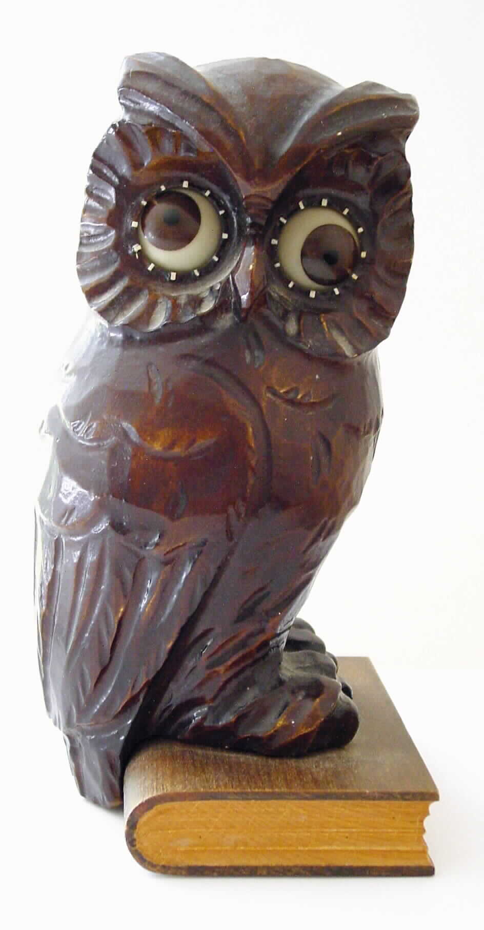 Oswald, German, "Wise Old Owl", rotating eye 30-hour timepiece, molded composition body on a carved wooden book base. c1930 . — Antique Clocks Price Guide