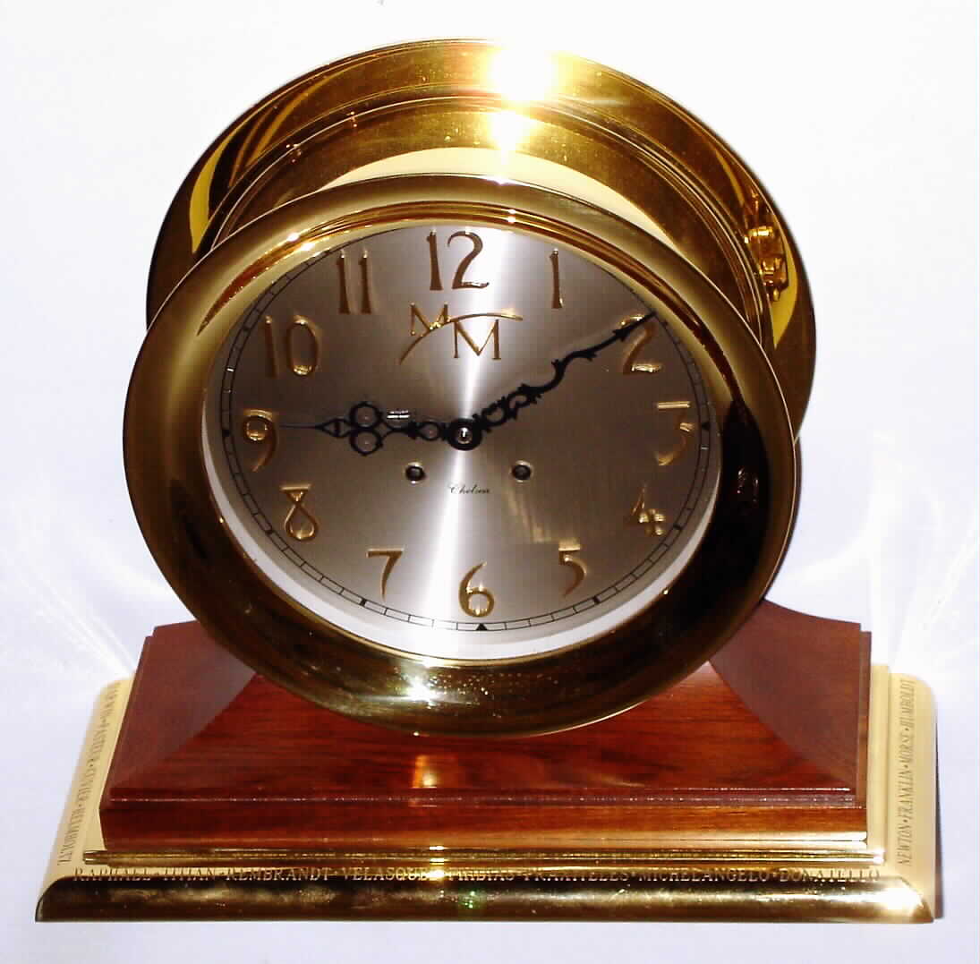 Chelsea Clock Co., Chelsea, Mass., "Limited Edition 2000 Millennium" ship's bell mantel clock with 8 day, spring driven, time and ship's bell strike movement in polished brass case on walnut base with brass platform engraved with the greatest names of the second millennium The dial is silvered metal with applied brass numerals and "MM", c2000 — Antique Clocks Price Guide