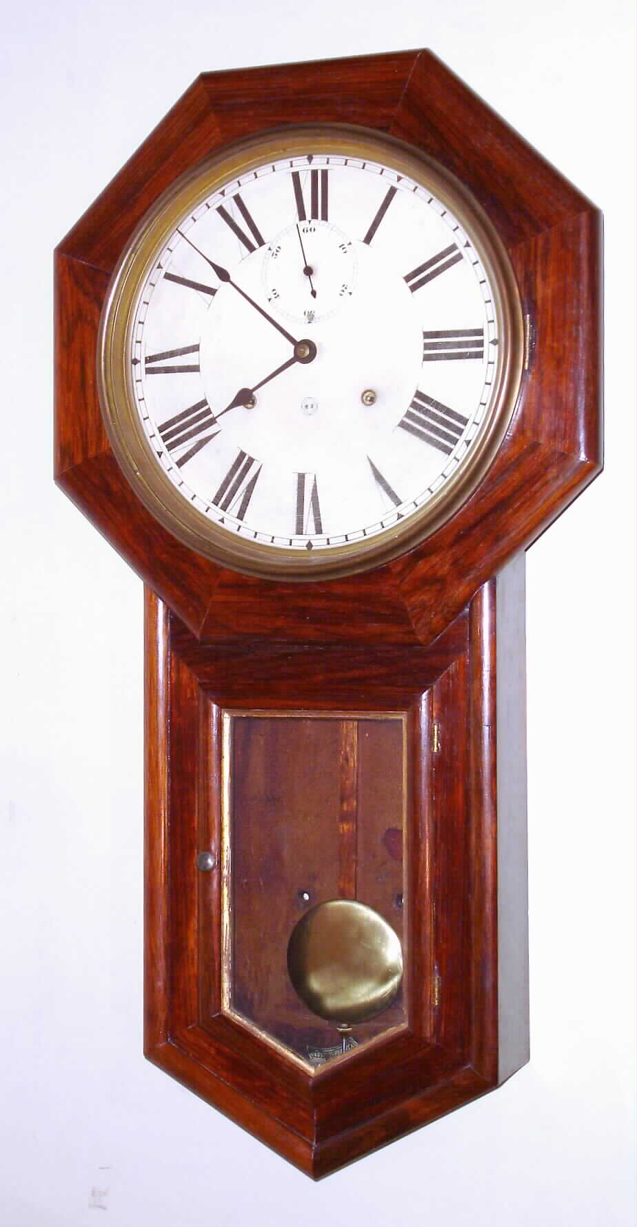Seth Thomas Clock Co., Thomaston, Conn., "World" wall clock, 15 day, time only, spring driven movement in rosewood veneer case with painted metal dial and second's bit, c1909 — Antique Clocks Price Guide