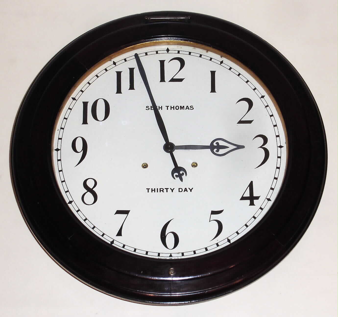 Seth Thomas Clock Co., Thomaston, Conn., "Gallery" wall clock, 30 day, time only, spring driven movement in mahogany case with painted metal 18" dial, c1909 — Antique Clocks Price Guide