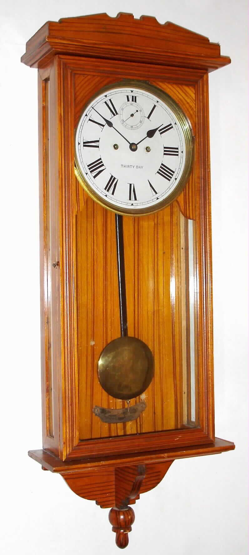 New Haven Clock Co., New Haven, Conn., "Vamoose" wall clock, 30 day, time only, double spring driven movement in grain painted oak case with painted metal dial, c1911 — Antique Clocks Price Guide