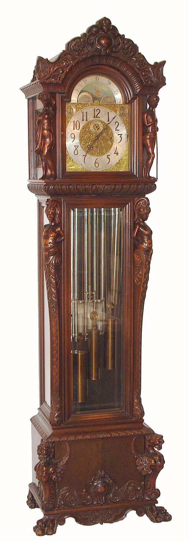 Winterhalder and Hofmeier, Schwarzenbach, Germany, triple tune, rolling moon tall case clock time and quarter chime on 9 tubes with option for Westminster, Whittington, or Winchester chimes + silent lever The movement is 8 day and has a three jar mercury pendulum housed in an elaborately and ornately carved mahogany case with well carved male and female figures flanking the hood and trunk and with gargoyles on the base on claw feet, and wtih moon phase dial. c1900 — Antique Clocks Price Guide
