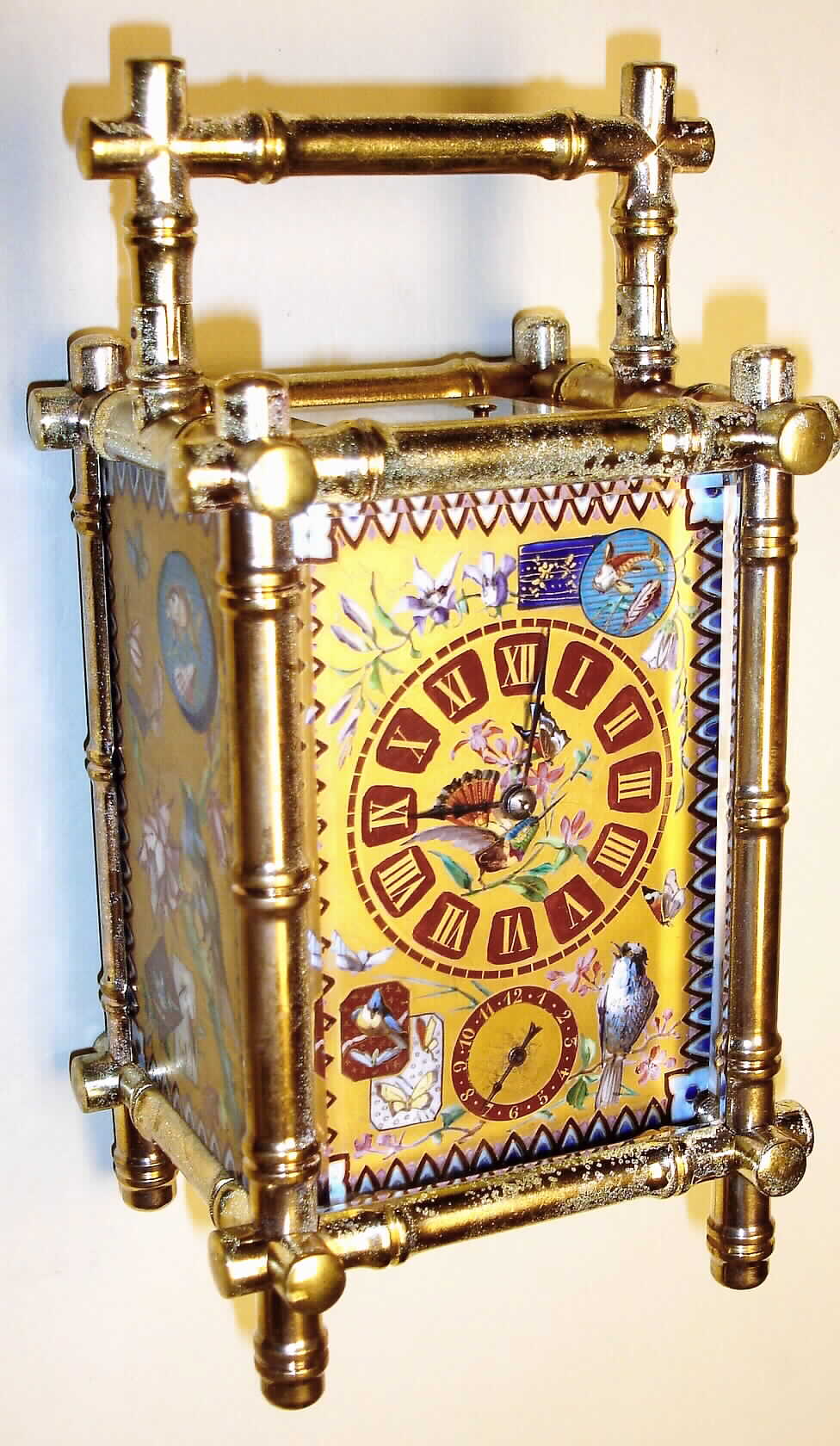 France, carriage clock in bamboo style brass case with enamel floral, butterfly, fish and avian decorations with 8 day, time, half hour strike and hour repeat, spring driven movement and similarily decorated Roman numeral dial, c1890 — Antique Clocks Price Guide