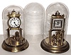 Clocks- 2 (Two) German 400 day anniversary timepieces, 1 with disk pendulum, plus an extra glass dome, 20th century