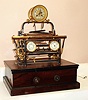 French, Guilmet, rare automaton "LOOM" from the industrial series, a conventional time and bell strike movement, with the exposed gears and loom driven by a weight falling down the right side of the base, the "motor" for the loom, a large heavily made clockwork movement with dual vane fan governor. Typical of Guilmet's designs, the loom includes a thermometer to the left and an aneroid barometer to the right , c1880