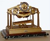 Dent, London, England, "Congreve Rolling Ball Clock", 8 day, spring driven, fusee movement with maintaining power is regulated by a rolling steel ball traversing an inclined plane every 15 seconds, tripping a lever, tilting the plane in the opposite direction, while registering 15 second intervals on the right dial, minutes on the center and hours on the left all on a marble base in a Plexiglass case, dated 1973