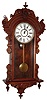 Wm. Gilbert and Co., Winsted, Conn. "Columbia" wall clock, 8 day, time and strike, spring driven movement in a walnut case with painted metal dial, c1901