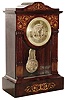 French Empire mantel clock, 8 day, time and bell strike, spring driven movement with knife edge suspension and fancy pendulum in a mahogany with inlay and brass dial with embossed center and fancy cast brass bezel, c1830