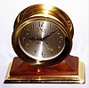 Chelsea Clock Co., Chelsea, Mass., "Limited Edition 2000 Millennium" ship's bell mantel clock with 8 day, spring driven, time and ship's bell strike movement in polished brass case on walnut base with brass platform engraved with the greatest names of the second millennium The dial is silvered metal with applied brass numerals and "MM", c2000