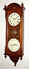 Seth Thomas Clock Co., Thomaston, Conn., "Office Calendar No. 10" earlier version with fret work between the two dials, 8 day, time and perpetual calendar, weight driven movement in walnut case similar to the "Regulator No. 6" with painted metal double dials, c1886