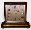 D. Gumbiner, Swiss desk clock or partners clock, 8 day, time only, spring driven movement in brass case with double sided Arabic numeral metal dial, c1910