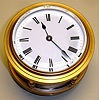 French, rare Round cased fusee carriage clock with dial facing upwards , 8 day, time only, spring driven movement with 2 plane lever escapement in brass case with four brass feet, and a cylinder of glass surrounding the movement, allowing the whole movement to be visible, c1886