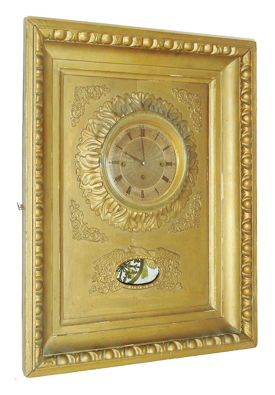 Austria, Ramenuhr or picture frame clock, the gilt frame with egg and dart molding, brass engine turned bezel with gilt acanthus carved surround, applied brass ornament with eagle at aperture for pendulum, silvered engine turned Roman numeral dial with blued steel hands, 3 train brass movement of two day duration, grand sonnerie striking on two gongs, pierced brass pendulum with silk thread suspension, c1830 — Antique Clocks Price Guide