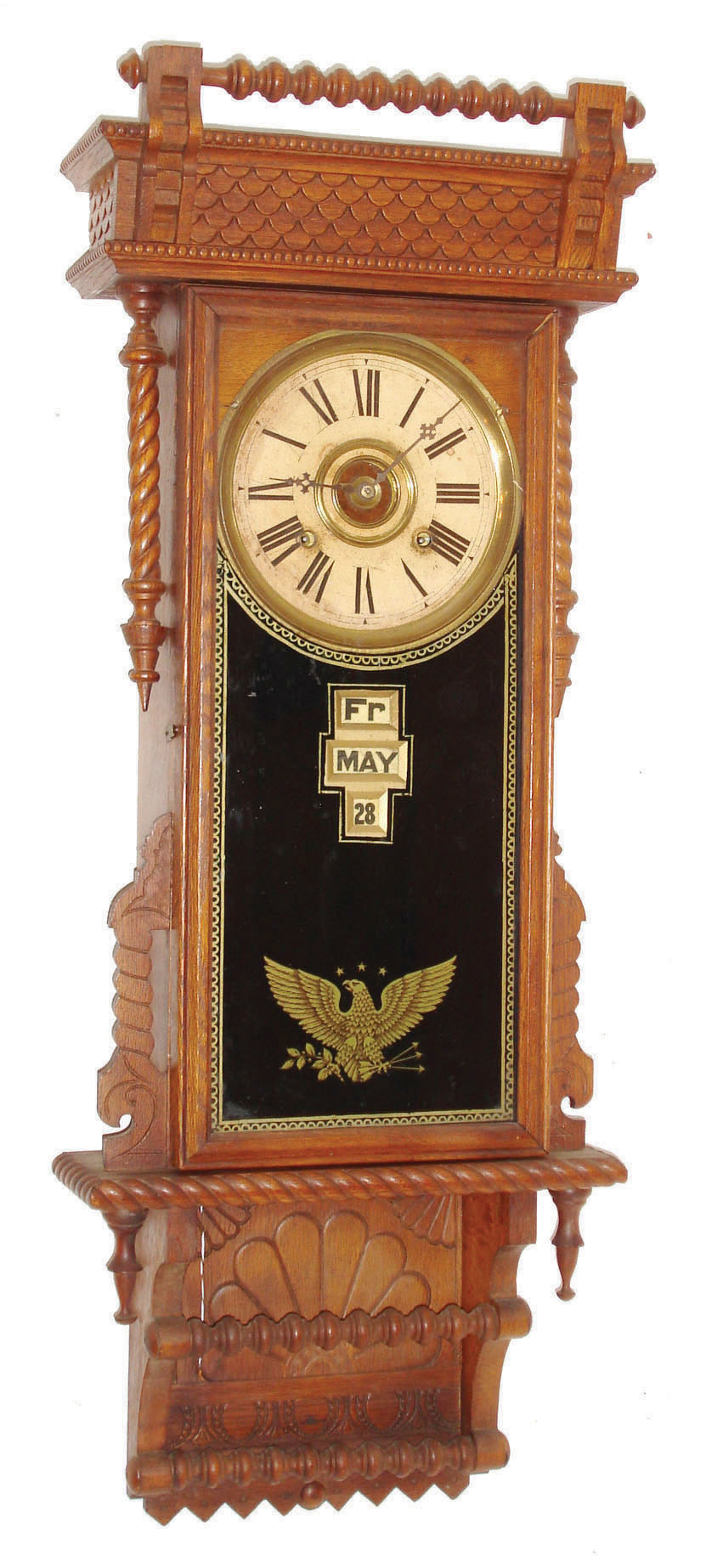 William L. Gilbert Clock Co., Winsted, Conn., "Sharon", wall clock, 8 days, time, strike and McCabe's patent with digital calendar, spring driven movement in an oak case with reverse painted tablet and papered metal dial, c1890 — Antique Clocks Price Guide