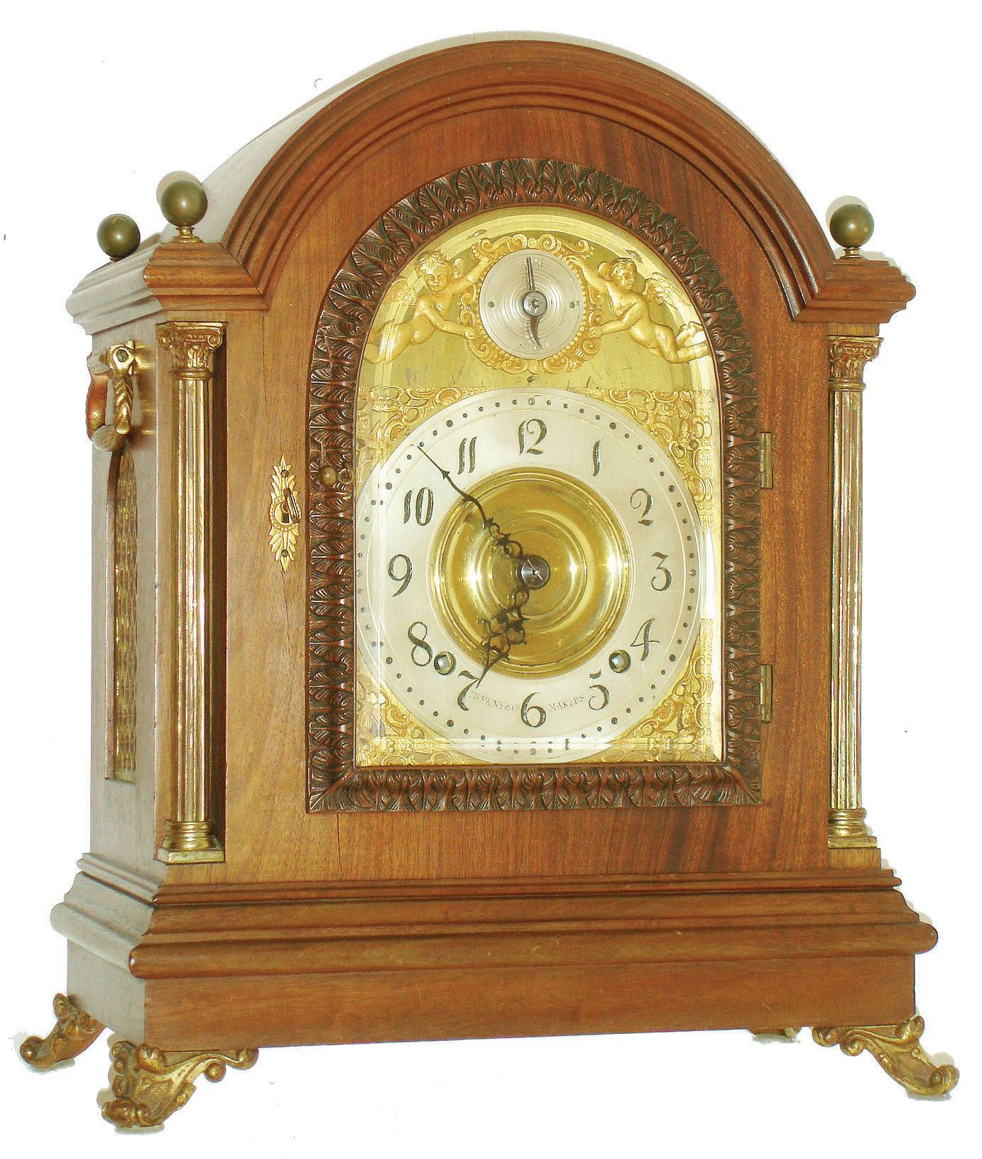 Tiffany & Co. Makers, New York, large mahogany bracket clock with quarter striking, mahogany case with cast brass scroll feet, brass Corinthian columns flanking the arched, cast brass door with acanthus leaf decoration and thick beveled glass, each side with fabric lined brass fret and heavy cast carrying handles, the four corners of the top with spherical brass finials, case back with mahogany door and fabric lined screen, thick brass composite dial with gilt spandrels, Arabic numeral silvered dial marked "Tiffany & Co. Makers", dial arch with gilt putti flanking silvered Strike/ Silent indicator, pierced steel hands, very substantial brass movement with Brocot escapement, back plate  marked "Tiffany & Co. Makers Patented Nov. 7th 1882" and with the number 716, full Westminster chimes and hour striking on 5 gongs, original pendulum and key, c1890 — Antique Clocks Price Guide