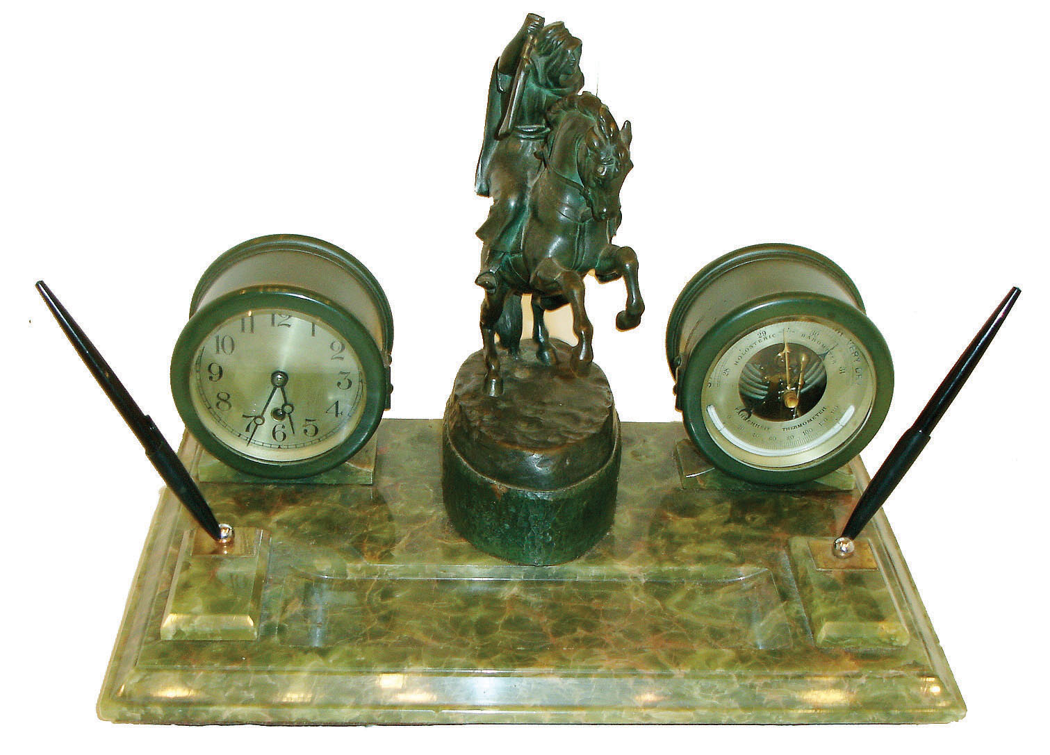 Chelsea Clock Co., Chelsea, Mass., a substantial bronze and green onyx writing stand, the stone base with molded edge, raised holders each containing a "Parker 51" fountain pen, and with blotter tray, Chelsea 4 1/2" timepiece and matching barometer in green finished brass cases, flanking a patinated, signed bronze sculpture of an Arab on horseback holding a long gun, by Theodor Ullmann, and cast at the Arthur Rubenstein foundry, Vienna, Austria, on a hammered plinth with bronze finish, c1920 — Antique Clocks Price Guide