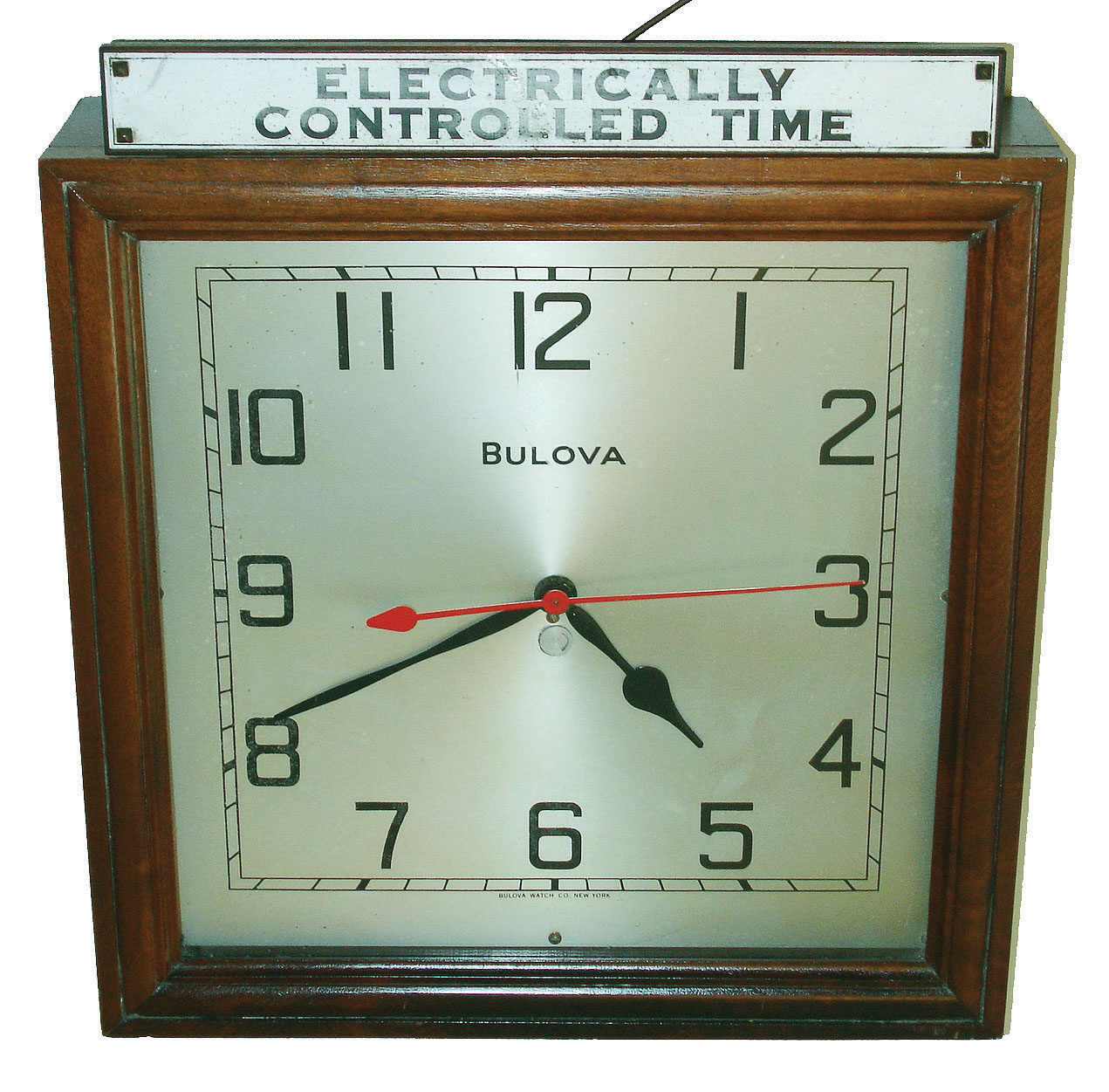 Bulova Watch Co., New York, "Electrically Controlled Time" plug-in square walnut wall clock, first half 20th century — Antique Clocks Price Guide