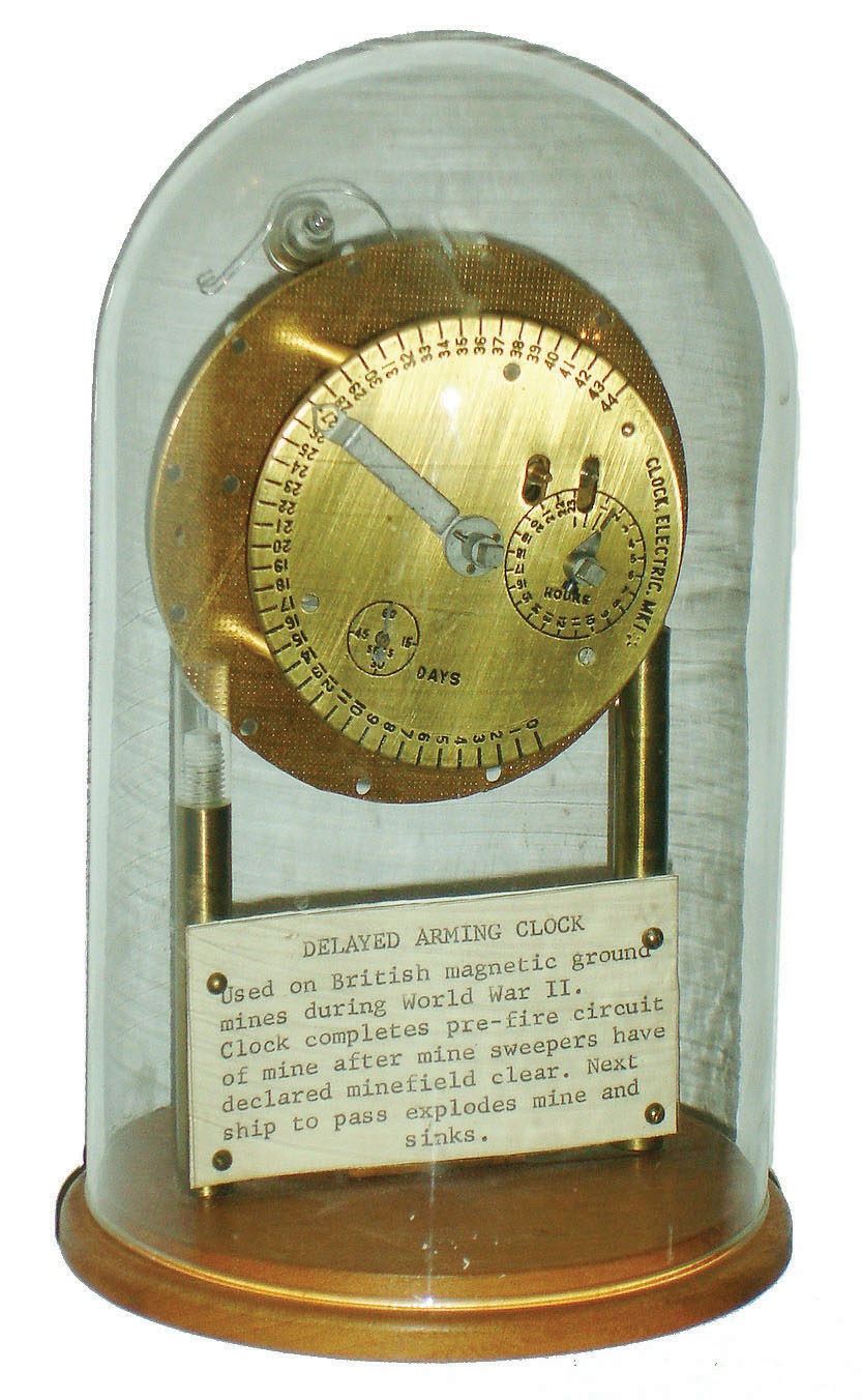 World War II "Delayed Arming Clock", naval mine timer on wood base under glass dome, c1940 — Antique Clocks Price Guide