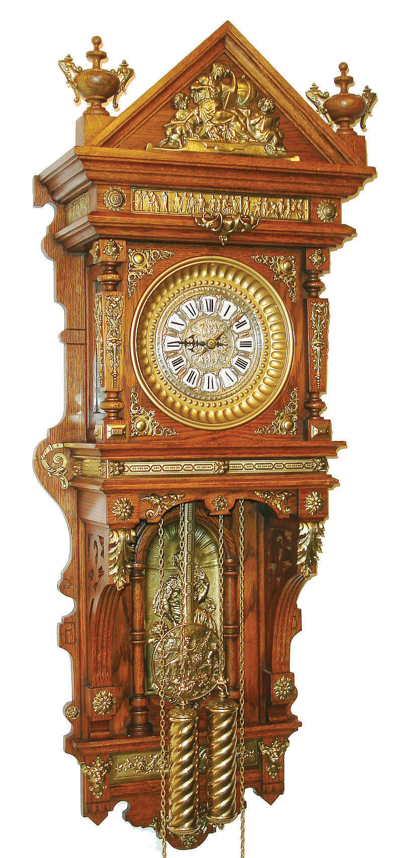 Ansonia Clock Co., New York, NY, "Antique Hanging" wall clock, 8 days, time and strike, spring driven movement in an oak case with ormolu appliques and embossed metal dial, c1904 — Antique Clocks Price Guide