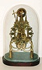 Single fusee, gothic style skeleton, time & single hour strike, european origin, mid 20th century, with old glass dome and base.